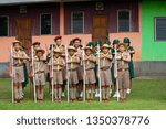 Small photo of Prachinburi, Thailand, Oct 8, 2017 - Line of boy scouts and girl guides present arms