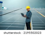Asian engineer solar cell factory working with safety helmet outdoor