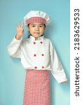Small photo of Little asian girls in chef uniform with okie pose.