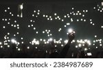Small photo of Many fun people lift hand up hold cell phone flash light. Fan crowd wave flashlights. Epic live music concert atmosphere. Big open air k pop arena. Cool night fest. Lot joy men hang out. Kpop chill.