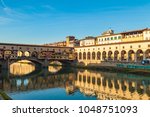 Arno river, houses and old Ponte Vecchio bridge, Florence, Tuscany, Italy