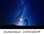 Small photo of Man looking at the stars through a telescope