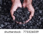 Coal mining : coal miner in the man hands of coal background. Picture idea about coal mining or energy source, environment protection. Industrial coals. Volcanic rock.