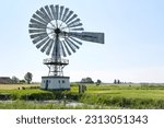 Small photo of Weidum, The Netherlands - May 28 2023: American wind engine or Herkules Metallicus from 1920 near Weidum in Friesland. Nowadays a reserve pumping station in case of serious flooding.
