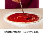 Pouring Tomato Sauce On A Pizza