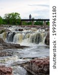 Small photo of The Big Sioux River tumbles over a series of rock faces in Falls Park, Sioux City, South Dakota, vertical