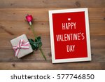 Happy valentine's day card, gift box and red rose on wood background, banner 