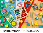 Small photo of Multicolored wooden blocks on red blue background. Trendy puzzle toys. Geometric shapes: square, circle, triangle, rectangle. Educational toys for kindergarten, preschool or daycare. Back to school