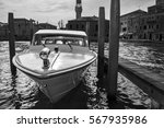 berthed boat on canal in Venice in a sunny day. (black and white version) 