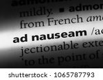 Small photo of ad nauseam word in a dictionary. ad nauseam concept.