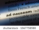 Small photo of ad nauseam word in a dictionary. ad nauseam concept.