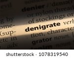 Small photo of denigrate word in a dictionary. denigrate concept