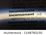Small photo of inconsonant word in a dictionary. inconsonant concept.