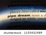 Small photo of pipe dream word in a dictionary. pipe dream concept.