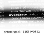 Small photo of overdraw word in a dictionary. overdraw concept.