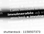 Small photo of invulnerable word in a dictionary. invulnerable concept.