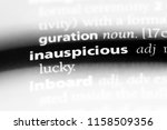 Small photo of inauspicious word in a dictionary. inauspicious concept.