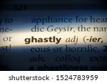 Small photo of ghastly word in a dictionary. ghastly concept, definition.