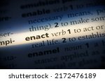 Small photo of enact word in a dictionary. enact concept, definition.