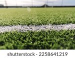 Close-up of mini soccer field lines. Background soccer pitch grass football stadium ground view. Ground football field grass macro