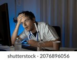 Small photo of portrait sad unhappy health care professional with headache stressed during night shift. Nurse doctor with migraine overworked overstressed.