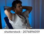Small photo of portrait sad unhappy health care professional with headache stressed during night shift. Nurse doctor with migraine overworked overstressed.