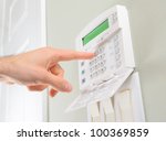 pressing the code on a house alarm
