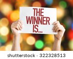 The Winner Is... placard with bokeh background