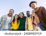 Small photo of Young group of people having fun together outdoors in a sunny day. Multiracial best friends bonding enjoying time together at city street. United millennial students laughing.