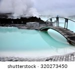 Blue lagoon, with its iconic bridge, revealing the stunning and tranquil beauty of its blue waters in Iceland, a natural wonder and tourist attraction
