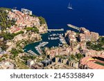 Aerial view of port Fontvieille at sunset, Oceanographic Museum of Monaco, South France, a lot of boats are moored in marina, view of city life from La Turbie mountain, mega yachts, luxury apartments