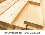 Piled lumber near a lumber mill ...