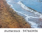 Small photo of A Windy Winter's Morning by the Sea and Shoreline. With Sand and Waves at Ebbtide