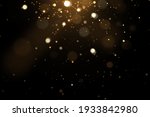 Festive abstract christmas texture, golden bokeh particles and highlights on dark background. High quality photo