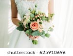 Beautiful bouquet. The bride is holding a bouquet in her hands. Flowers of the bride. The bride is waiting for the groom in the white room.