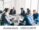  onstruction company management board members headed by grey-haired caucasian director analyzing company statistics during office meeting, consider stats diagrams making predictions