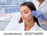Side view close-up photo of young brunette female came to cosmetologist to get PDO thread, Thread Lifting procedure. Aesthetic beauty anti aging, face lifting surgery. Chossing the best thread