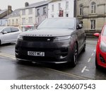 Small photo of 20th February 2024- A grey Range Rover Sport SE PHEV Auto, five door SUV, parked in the town center at Carmarthen, Carmarthenshire, Wales, UK.