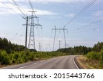 High voltage power lines over a road in Finland