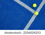Small photo of balls on a blue paddle tennis court