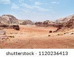    Wadi Rum desert, Jordan,  The Valley of the Moon. Orange sand, haze, clouds. Designation as a UNESCO World Heritage Site. National park outdoors landscape. Offroad adventures travel background.    