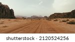 Small photo of Wadi Rum desert, Jordan, The Valley of the Moon. Orange sand, haze, clouds. Designation as a UNESCO World Heritage Site. National park outdoors landscape. Offroad adventures travel background.
