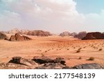 Small photo of Wadi Rum desert, Jordan, The Valley of the Moon. Orange sand, haze, clouds. Designation as a UNESCO World Heritage Site. National park outdoors landscape. Offroad adventures travel background.