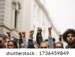 Arms Raised In Protest. Group...