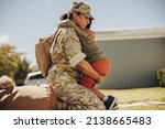 Small photo of Emotional military mom embracing her son after returning home from the army. Courageous female soldier reuniting with her young child after military deployment.