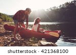 Young Man Pushes A Canoe In The ...