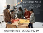 Children with teacher preparing for Black History Month
