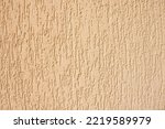 Texture of decorative plaster with a relief. Beige plaster. Close-up.
