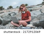 Small photo of Remote work.Girl freelancer works remotely on the seashore.workation, remote work,WFVH,Van Life vibes work from vacation home,work travel,remotely work.Travelling