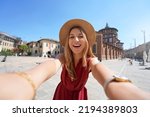 Smiling tourist takes selfie...
